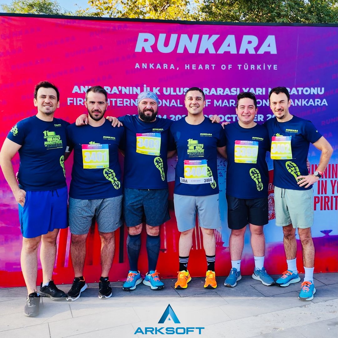 ARKSOFT team members posing at the 1st International Ankara Half Marathon with sponsorship banners