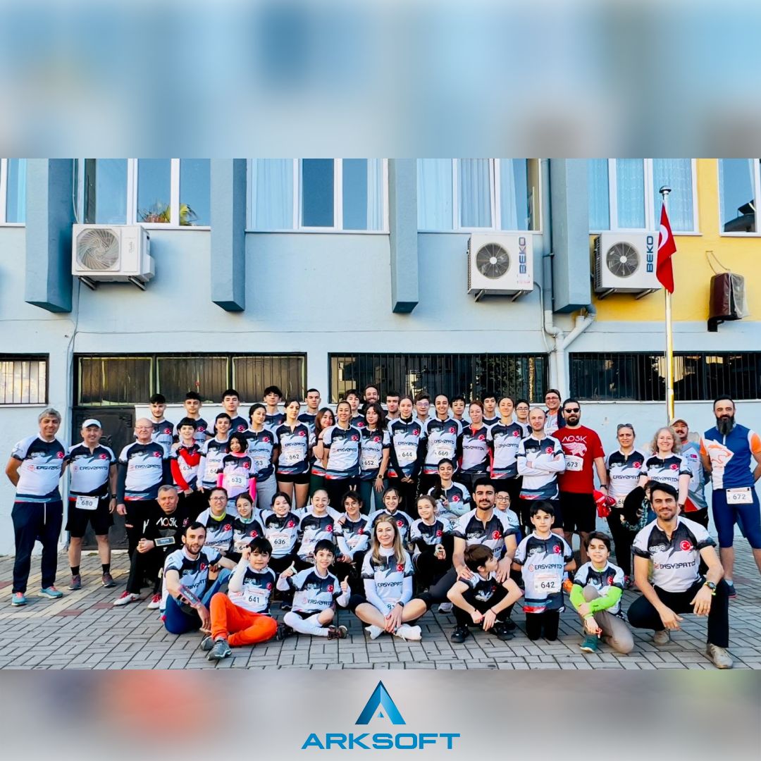 Large group of ARKSOFT team members gathering for a photo to support sports and team spirit, in front of the company building